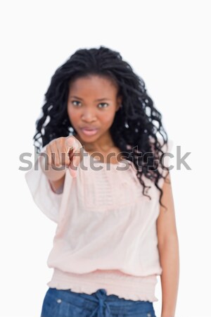 A girl is pointing straight at the camera against a white background Stock photo © wavebreak_media