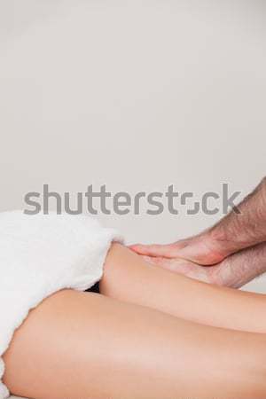 Chiropractor holding the heel of a patient in a room Stock photo © wavebreak_media