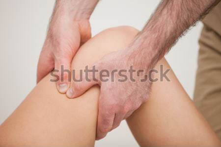 Knee of a patient being held by a physiotherapist in a room Stock photo © wavebreak_media