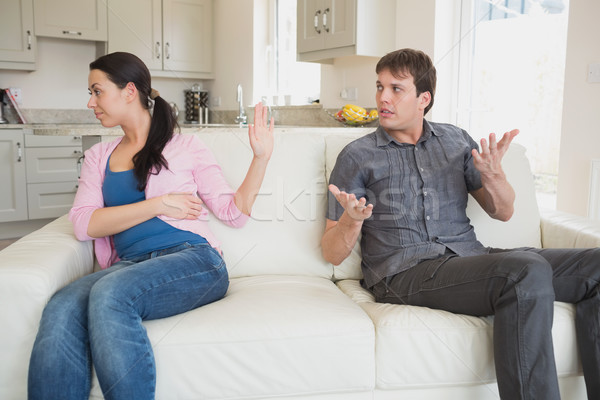 Stock photo: Young people disputing on the couch in the living room
