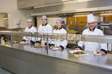 [[stock_photo]]: Quatre · chefs · plaques · cuisine · fond · restaurant