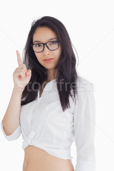 Woman in shirt and glasses pointing up Stock photo © wavebreak_media