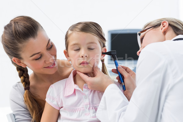 Girl being examined by doctor with otoscope Stock photo © wavebreak_media