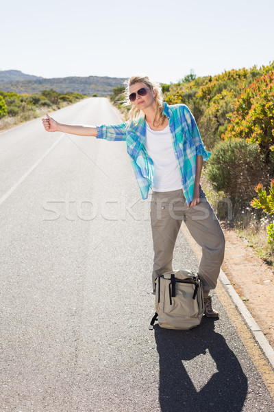 Attractive blonde hitch hiking on rural road Stock photo © wavebreak_media