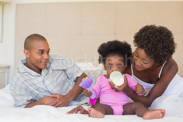 Happy parents with baby girl on their bed Stock photo © wavebreak_media