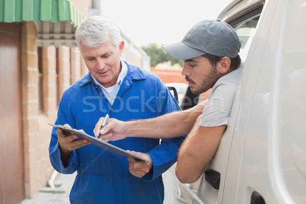 Delivery driver showing customer where to sign Stock photo © wavebreak_media