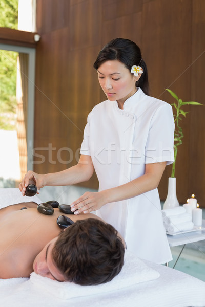 Man receiving stone massage at spa center Stock photo © wavebreak_media