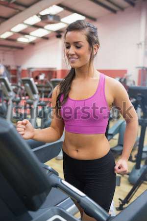 Stock photo: Pretty trainer looking at her stopwatch