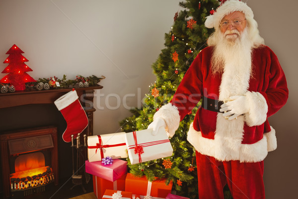Joyful santa delivering gifts at christmas eve Stock photo © wavebreak_media