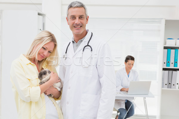 Veterinarian and cat owner smiling at camera  Stock photo © wavebreak_media