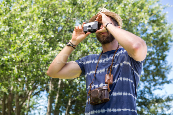 Handsome hipster using vintage camera Stock photo © wavebreak_media