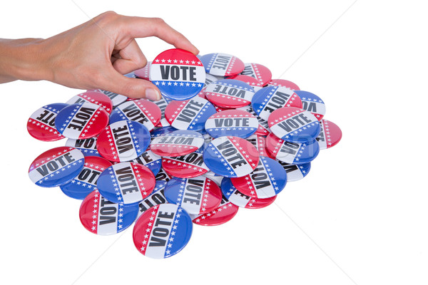 Hand showing vote badge behind pile of badge  Stock photo © wavebreak_media