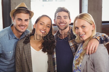 Smiling friends standing and taking selfies Stock photo © wavebreak_media