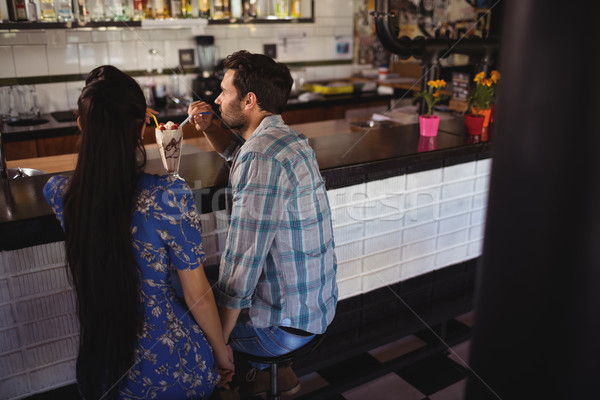 Couple holding hands while having milkshake at counter Stock photo © wavebreak_media