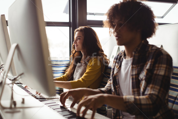 Audio engineers playing electric keyboard Stock photo © wavebreak_media