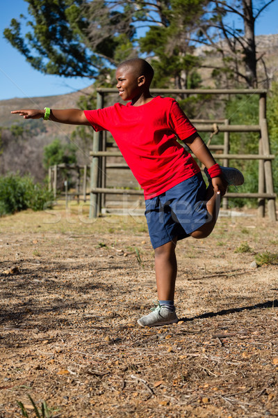 Boy performing stretching exercise during obstacle course training Stock photo © wavebreak_media