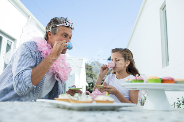 Father and daughter in fairy costume having a tea party Stock photo © wavebreak_media