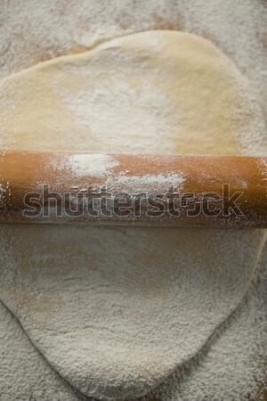 Overhead view of rolling pin on rolled dough Stock photo © wavebreak_media