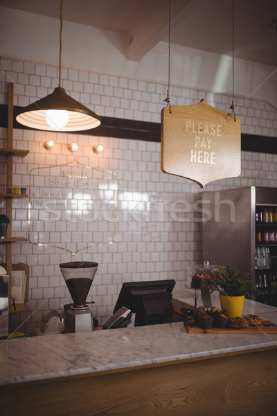 Text and pendant light hanging over counter against white wall Stock photo © wavebreak_media