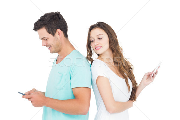 Souriant couple smartphones Retour blanche heureux Photo stock © wavebreak_media