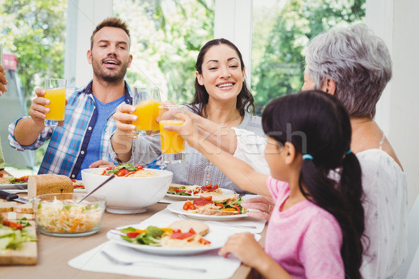 Famille heureuse jus table à manger femme maison [[stock_photo]] © wavebreak_media