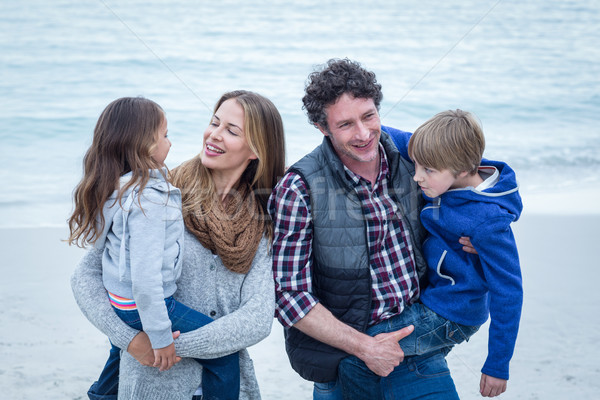 Parents carrying children while enjoying at beach Stock photo © wavebreak_media