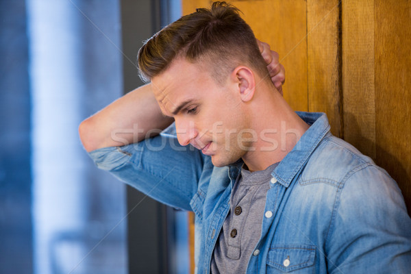 Depressed man standing by door Stock photo © wavebreak_media