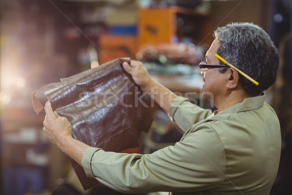 Shoemaker examining a piece of leather Stock photo © wavebreak_media