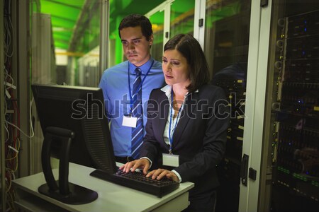 Technicians using digital tablet while analyzing server Stock photo © wavebreak_media