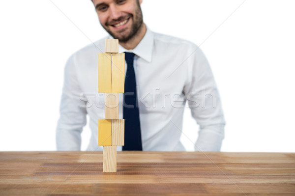 Businessman placing wooden block on a tower Stock photo © wavebreak_media