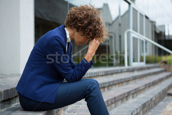 Depressed businesswoman sitting in the premises Stock photo © wavebreak_media