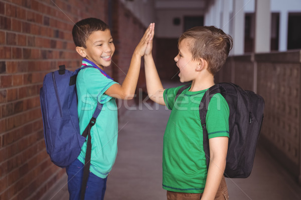 Uczniowie inny high five szczęśliwy zespołu chłopca Zdjęcia stock © wavebreak_media