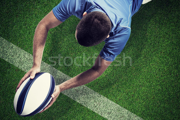 Composite image of rugby player lying in front with ball Stock photo © wavebreak_media