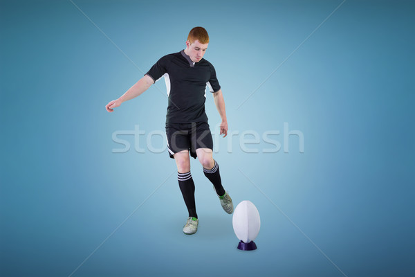 Stock photo: Composite image of rugby player doing a drop kick