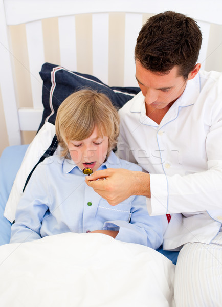 Handsome father checking his son's temperature Stock photo © wavebreak_media