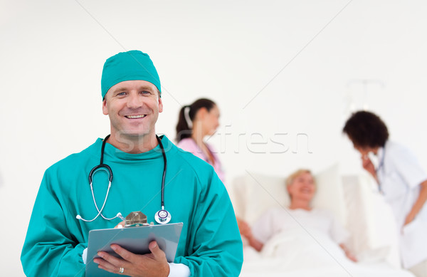 Stock photo: Cofident surgeon with his team in hospital 
