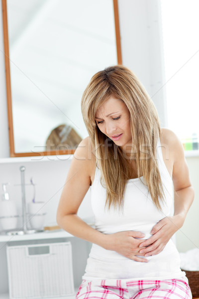 Suffering woman having a stomachache in her bathroom at home Stock photo © wavebreak_media