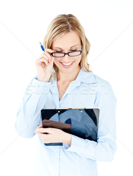 Glowing businesswoman wearing glasses and holding a clipboard against a white background Stock photo © wavebreak_media