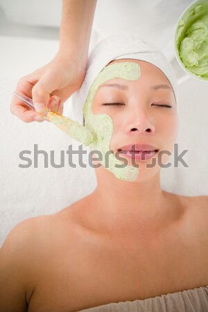 Portrait of a smiling woman having massage oil versed on her back Stock photo © wavebreak_media