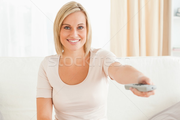 Charming woman watching television with the camera focus on the model Stock photo © wavebreak_media