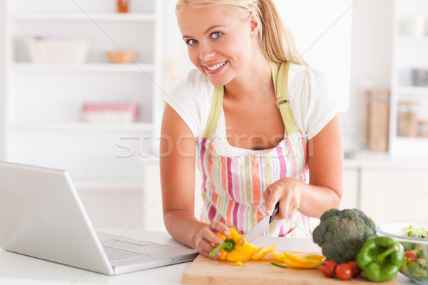 Close up of a blonde woman using a laptop to cook in her kitchen Stock photo © wavebreak_media