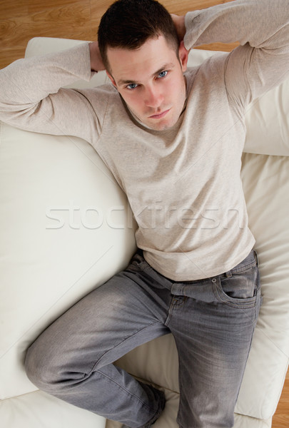 Portrait jeune homme canapé regarder caméra [[stock_photo]] © wavebreak_media