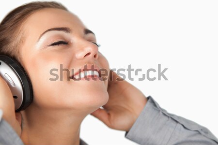 Stock photo: Close up of businesswoman enjoying music against a white background