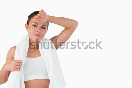 Sporty woman wiping off sweat against a white background Stock photo © wavebreak_media