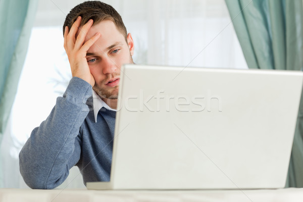 Young businessman annoyed by his laptop in his homeoffice Stock photo © wavebreak_media
