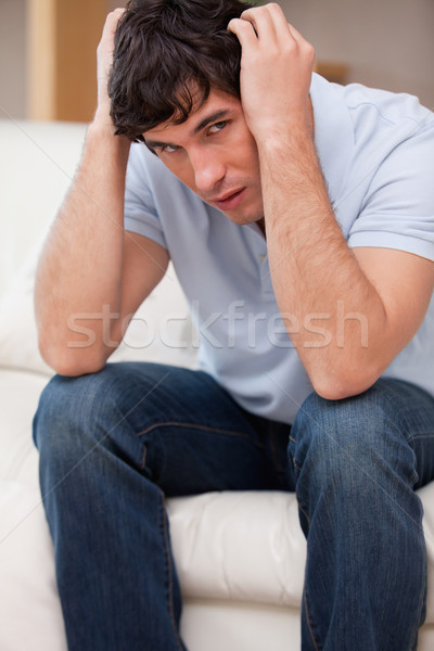 Frustrated young man sitting on the sofa Stock photo © wavebreak_media