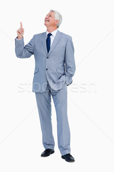 Businessman pointing up against white background Stock photo © wavebreak_media