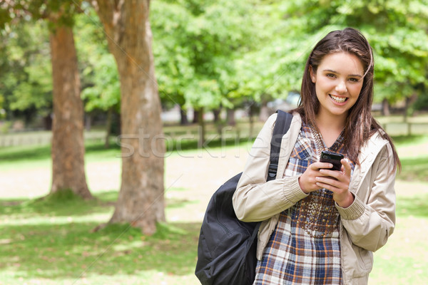 Portrait of a young student using a smartphone in a park Stock photo © wavebreak_media