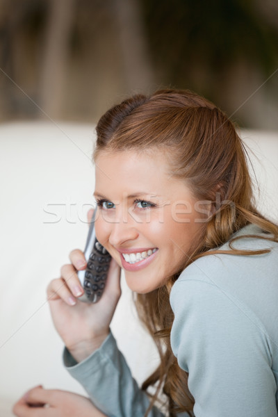 Woman smiling while phoning indoors Stock photo © wavebreak_media