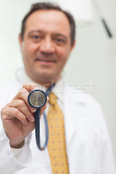 Doctor holding a stethoscope in an examination room Stock photo © wavebreak_media